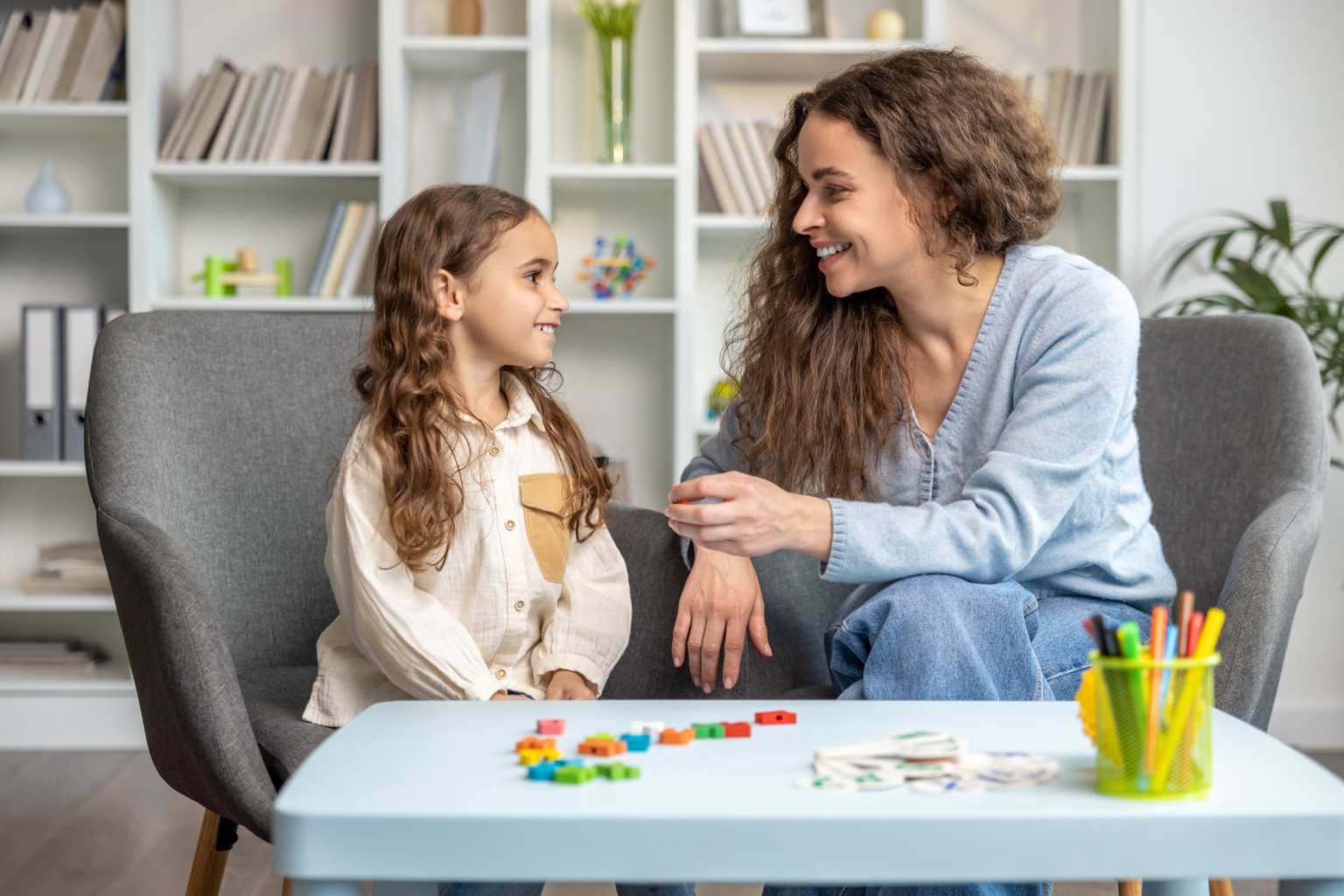 Cute Long Haired Girl Having Speech Therapy Session With The Doctor